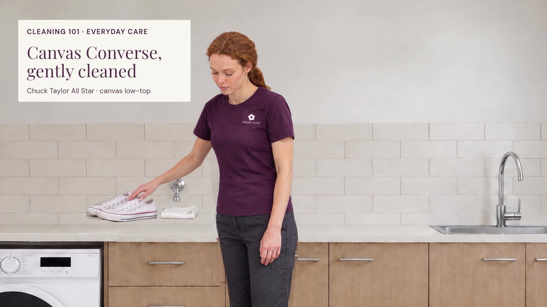 Simply Maid’s original auburn cleaner demonstrates gentle hand cleaning of white canvas Converse in the laundry.